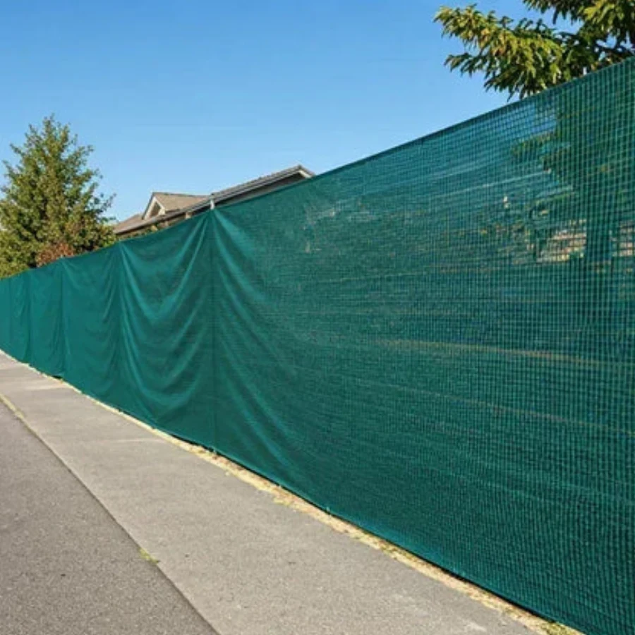 Temporary construction fence with green privacy screen