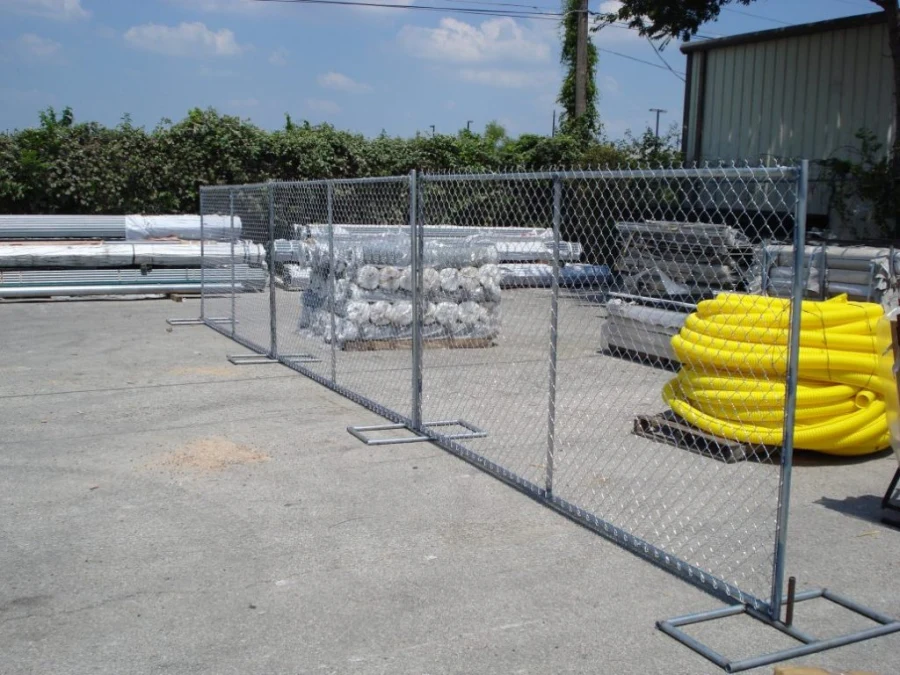 Temporary chain link fence panels installed around a material yard